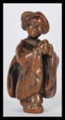 A 19th Century Japanese Meiji period carved netsuke depicting a Geisha lady, signed character