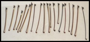 A collection of 20th Century violin bows, most bows being brazilwood and Pernambuco with ebony,
