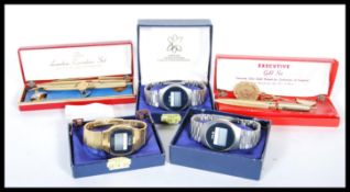 Three Beta digital wrist watches having brushed metal straps together with three brushed gold tone