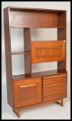 A retro vintage 1960's teak wood room divider bookcase having a configuration of open shelves and