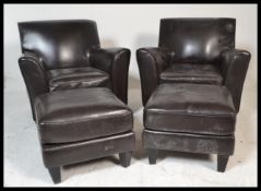 A pair of contemporary black leather club armchairs. Raised on block feet, the angled seat frames