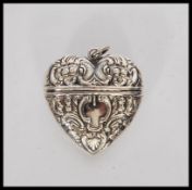 A silver heart shaped Vesta case having scroll and floral embossed decoration. Stamped 925. Weighs