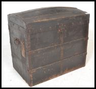 A vintage 19th century wooden and canvas bound steamer trunk. The dome top with open storage within.