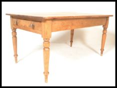 A Victorian 19th century country pine dining table. Raised on turned legs with fitted stretcher.