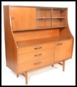 A 20th century retro teak wood highboard sideboard credenza, having a configuration cupboards and