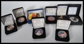 A collection of Elvis Presley U.S. silver eagle coins from the year 2002, along with an Elvis