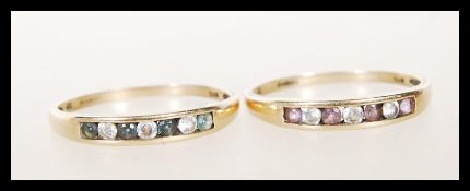 Two stamped 375 9ct gold rings having channel set round cut stones, one having blue and white