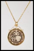 A stamped 9ct gold necklace having a fine rope twist chain having a 1981 gold Charles and Diana coin