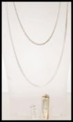 A silver hallmarked ingot pendants along with two chain necklaces including a snake chain and linked