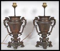 A pair of late 19th Century French bronzed spelter urns having a later conversion to table lamps. Th