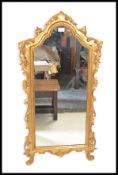 A 19th Century giltwood Rococo style wall mirror of arch form, having gilt detailing with C scroll