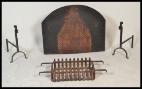 An early to mid 20th Century wrought iron fire grate / basket of rectangular form, raised on a