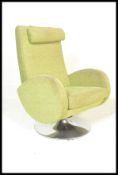 A vintage style swivel green easy armchair, scroll arms upholstered with in green wool, raised on