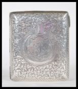 A silver hallmarked cigarette case having engraved foliate decoration with a circular belt