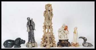 A group of six 20th Century carved soapstone figures to include, four elders one being seated on a