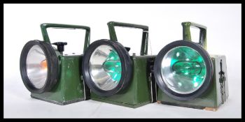 A group of three 20th Century military Bardic lamps finished in green, having serial numbers to side