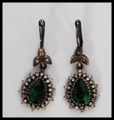 A pair of silver Renaissance style drop earrings set with green semi precious stones and cz's.