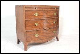 A 19th Century Georgian mahogany bow front chest of three graduating drawers  with pull slide