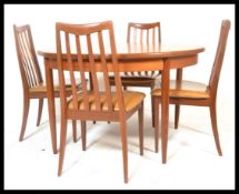 A retro 20th Century G-Plan Fresco teak wood circular dining table raised on turned legs with