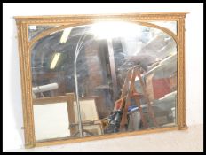 A Victorian 19th century carved gilt overmantel mirror of rectangular form having inset glass mirror