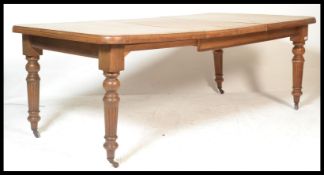 A good Victorian 19th century solid oak twin leaf wind out dining table. Raised on fluted, reeded