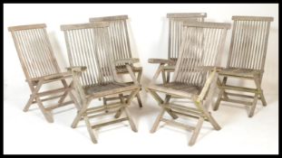 A set of five 20th Century well weathered teak wood folding metamorphic garden chairs, slat