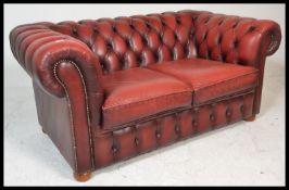 A 20th Century Oxblood leather upholstered chesterfield two seater sofa, having buttoned rounded