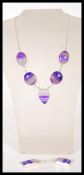 A demi parure necklace and earrings set to include a necklace set with  five purple agate