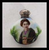 A early 20th Century ceramic perfume bottle having Gashua girl to front and silver hallmarked