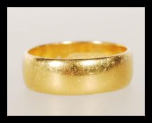 A hallmarked 22ct gold wedding band ring of typical form. Hallmarked Birmingham 1989. Weight 5.8g.