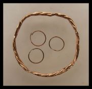 A 9ct gold rope twist slave bangle being stamped 375 together with 3 9ct gold marked creole