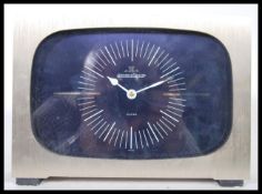 A 1970's Jaeger-LeCoultre table clock set within a brushed aluminium case with back cover having