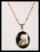 A stamped 14ct gold twisted link necklace chain with a stamped 14ct gold pendant locket having an