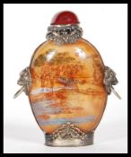 A 19th century Chinese glass perfume scent bottle having light red ground and oriental scene