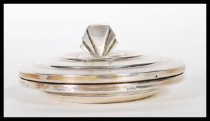 A silver hallmarked Art Deco 1930's dressing table powder pot having an engine turned stepped design