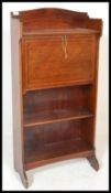An Edwardian mahogany inlaid student bureau. The fall front bureau with appointed interior being set