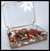 A vintage glass counter top shop display case having brass fittings and a red velvet interior