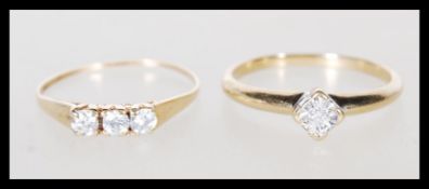 A hallmarked 9ct gold ring set with three white stones (hallmarked Sheffield 1982, size m.5),