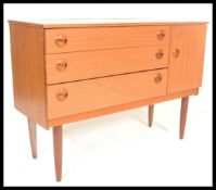 A vintage 1970's teak wood veneer sideboard credenza, having a configuration of three drawers to the