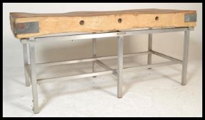 A large 20th century butchers block of Industrial form being rectangular in form and raised over a