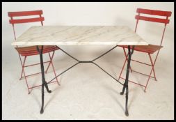 A 20th Century cast iron marble topped garden / conservatory table together with a pair of vintage