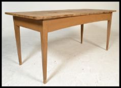 An early 20th Century distressed scrubbed pine farmhouse plank top dining table, the table of