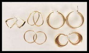A selection of 9ct gold hoop earrings of differing styles to include round hoops, oval hoops,