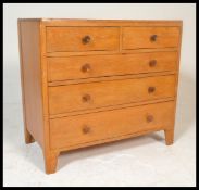 A 20th Century 1962 light oak 'utility' chest of drawers in the manner of Heal's, with two short