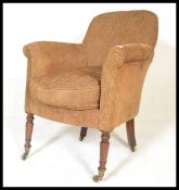 A Victorian style oak and woollen upholstered bedroom armchair. Raised on turned oak legs with brass