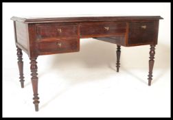 A Georgian style mahogany and leather writing table desk. Raised on turned legs with  a series of
