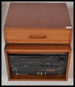 A vintage 20th Century teak wood cased music cabinet in the manner of G Plan containing a Garrard