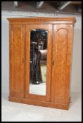 A Victorian satin wood triple wardrobe compactum. Raised on a plinth base having a series of