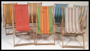 A collection of seven vintage retro mid 20th century wooden and canvas upholstered metamorphic