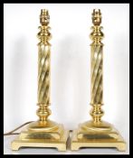 A pair of 20th Century tall brass twist column table lamps in the form of candlesticks, the